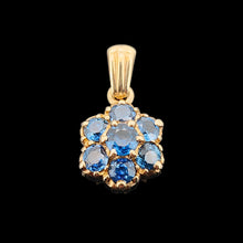 Load image into Gallery viewer, A yellow gold pendant with seven round sapphires, on a black background
