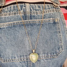 Load image into Gallery viewer, Heart-shaped pendant necklace modelled against denim
