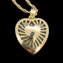 Load image into Gallery viewer, Gold heart-shaped pendant on a black background

