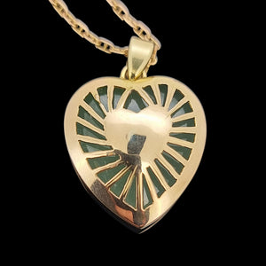 Gold heart-shaped pendant on a black background