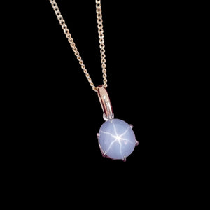 9ct Yellow and White Gold Star Sapphire Pendant, 5.50ct on a black background