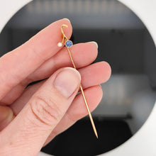 Load image into Gallery viewer, A sapphire and pearl tie pin in yellow gold, held in a hand
