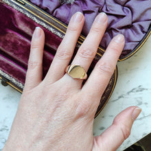 Load image into Gallery viewer, A yellow gold shield shaped signet ring, modelled on a hand
