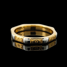 Load image into Gallery viewer, An eight sided band ring in gold and platinum with floral engraving, on a black background
