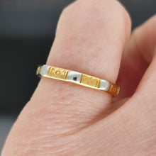 Load image into Gallery viewer, An eight sided band ring in gold and platinum with floral engraving, modelled on a little finger
