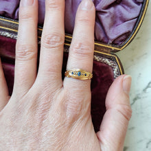 Load image into Gallery viewer, A yellow gold five stone sapphire and diamond ring, modelled on a hand
