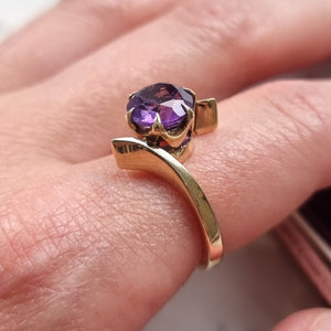 Gold ring with an amethyst modelled on a finger