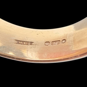 Vintage 9ct Yellow Gold Opal Crossover Dress Ring close-up of the hallmark and maker's mark, on a black background