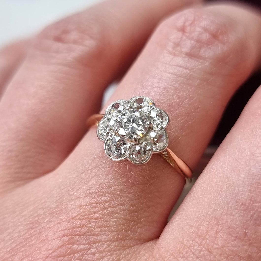 Diamond ring on a finger with a soft focus background