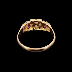 Gold ring with pearls, diamonds and rubies on a black background