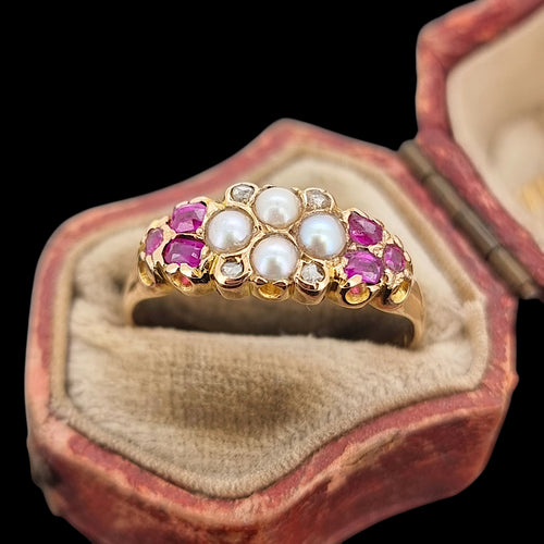 Gold ring with pearls, diamonds and rubies in an open antique jewellery box