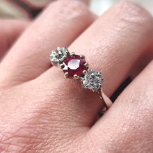 Load image into Gallery viewer, Ring with a ruby and two diamonds modelled on a finger
