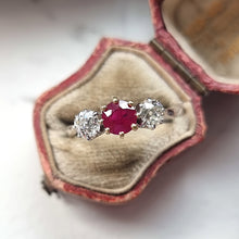 Load image into Gallery viewer, Vintage ring with a central ruby flanked by two diamonds in an open antique ring box

