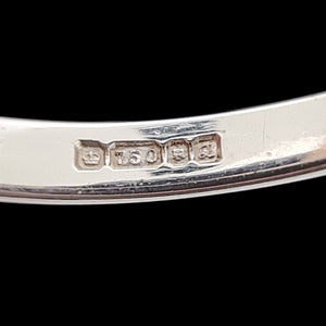 A close-up of an 18ct gold London 1990 hallmark