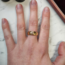 Load image into Gallery viewer, A solitaire old cut diamond gypsy set ring in yellow gold, modelled on the middle finger of a hand
