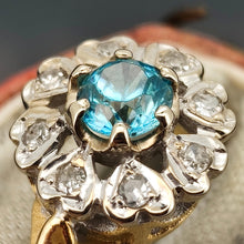 Load image into Gallery viewer, Close-up of a blue zircon and diamond flower cluster ring in yellow and white gold
