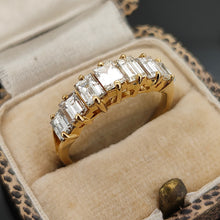 Load image into Gallery viewer, A seven stone baguette cut diamond graduated ring in yellow gold, in a ring box

