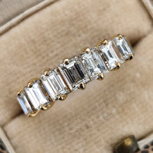 Load image into Gallery viewer, A seven stone baguette cut diamond graduated ring in yellow gold, in a ring box
