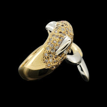 Load image into Gallery viewer, A yellow and white gold dolphin ring with diamonds and ruby eyes, on a black background
