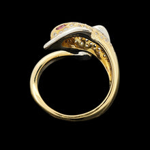 Load image into Gallery viewer, A yellow and white gold dolphin ring with diamonds and ruby eyes, on a black background
