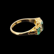 Load image into Gallery viewer, Gold ring with emeralds and diamonds on a black background
