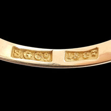 Load image into Gallery viewer, Close-up of 18CT stamp and maker&#39;s mark inside a gold ring shank, on a black background
