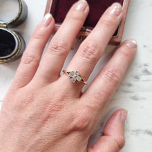 Load image into Gallery viewer, Hand wearing a gold ring with cross design on a marble surface
