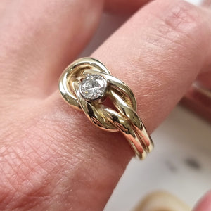 Gold ring with a diamond on a finger