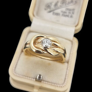 Gold ring with a diamond in an open antique ring box