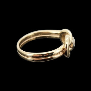 Gold ring with a diamond on a black background