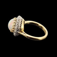 Load image into Gallery viewer, Gold ring with opal and diamond accents on a black background
