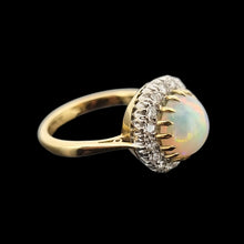 Load image into Gallery viewer, Gold ring with an opal stone and diamond accents on a black background
