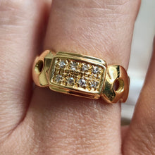 Load image into Gallery viewer, A yellow gold band with two rows of round diamonds, modelled on a hand
