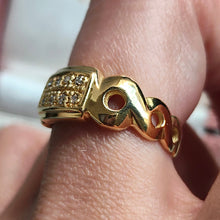 Load image into Gallery viewer, A yellow gold band with two rows of round diamonds, modelled on a hand
