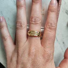 Load image into Gallery viewer, A yellow gold band with two rows of round diamonds, modelled on a hand
