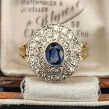 Load image into Gallery viewer, An oval sapphire and diamond cluster ring in yellow and white gold, in an antique ring box
