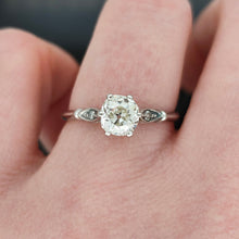 Load image into Gallery viewer, A diamond solitaire ring in platinum, modelled on a hand
