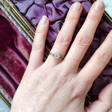 Load image into Gallery viewer, A diamond solitaire ring in platinum, modelled on a hand
