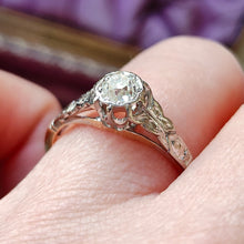 Load image into Gallery viewer, An old cut diamond solitaire ring in gold and platinum, modelled on a hand
