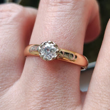 Load image into Gallery viewer, A single stone old cut diamond ring on a yellow gold band with white gold shoulder details, modelled on a hand
