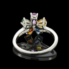 Load image into Gallery viewer, A multi-coloured gemstone flower shaped ring in white gold, on a black background
