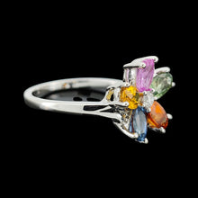Load image into Gallery viewer, A multi-coloured gemstone flower shaped ring in white gold, on a black background
