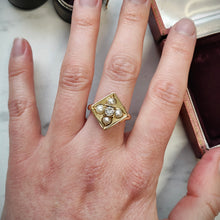 Load image into Gallery viewer, A pearl and diamond square shaped ring in yellow gold, modelled on the middle finger of a hand
