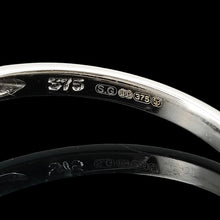 Load image into Gallery viewer, A white gold ring shank laser hallmarked as 9 carat gold, with a London assay stamp and 375 stamp
