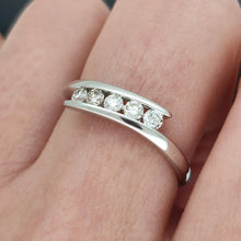 Load image into Gallery viewer, A white gold five stone diamond crossover ring, modelled on a hand
