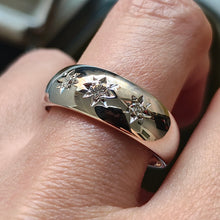 Load image into Gallery viewer, A three stone star set diamond band in white gold, modelled on a hand
