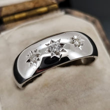 Load image into Gallery viewer, A three stone star set diamond band in white gold, in an antique ring box
