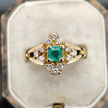 Load image into Gallery viewer, An emerald and diamond compass set cluster ring in yellow gold with split shoulders, in an antique ring box

