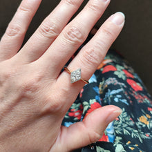 Load image into Gallery viewer, A rhombus shaped four stone diamond ring in yellow gold and platinum, modelled on a hand
