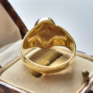 Vintage 18ct Gold Floral Signet Ring behind head